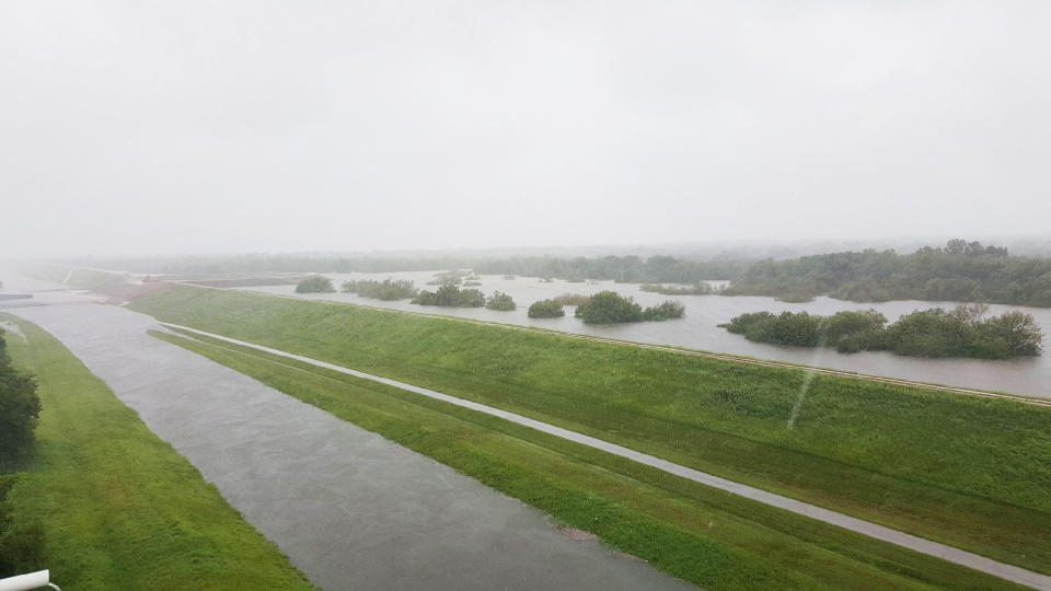 (Photo: Police block a flooded road near the Barker and Addicks reservoirs in Houston)