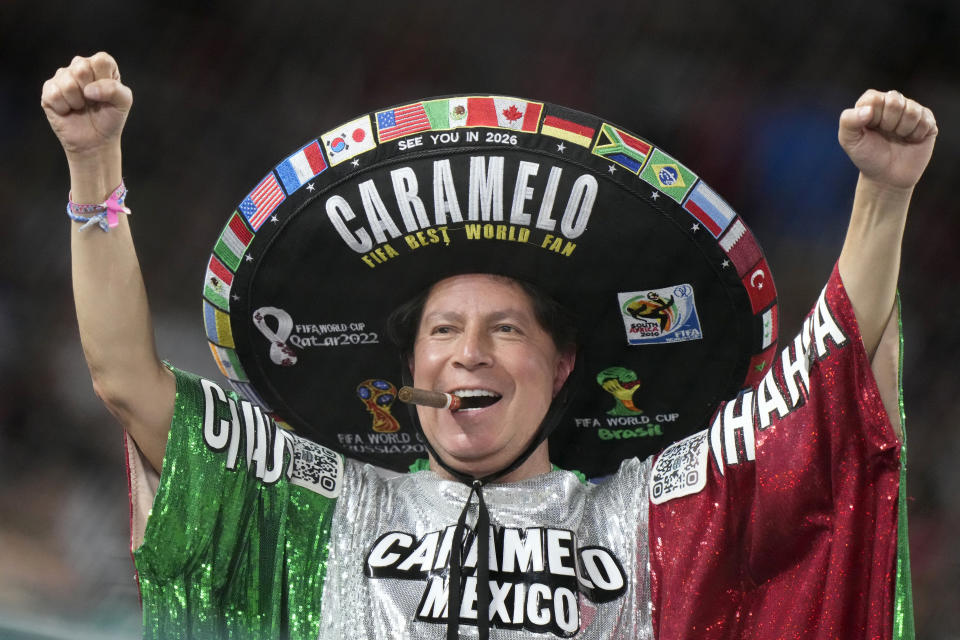 A Mexico fan cheers during the fourth inning of a World Baseball Classic game between Japan and Mexico, Monday, March 20, 2023, in Miami. (AP Photo/Wilfredo Lee)