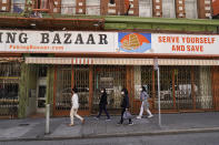 A group of women walk past a gated and closed Chinatown storefront that is for lease in San Francisco, Monday, May 23, 2022. Chinatowns and other Asian American enclaves across the U.S. are using art and culture to show they are safe and vibrant hubs nearly three years after the start of the pandemic. From an inaugural arts festival in San Francisco to night markets in New York City, the rise in anti-Asian hate crimes has re-energized these communities and drawn allies and younger generations of Asian and Pacific Islander Americans. (AP Photo/Eric Risberg)