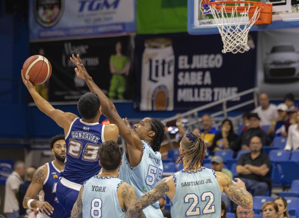 Bayamón Vaqueros' Bryan Gonzalez shoots against Guaynabo Mets' Jerome Meyinsse, during their basketball game at the Ruben Rodríguez Coliseum in Bayamón, Puerto Rico, Monday, July 1, 2024. Puerto Rico’s professional basketball league is experiencing a renaissance thanks to reggaeton stars like Bad Bunny, Ozuna and Anuel AA, who are stepping into the financial game, buying local teams and helping to stack up a loyal fan base. (AP Photo/Alejandro Granadillo)