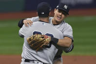 New York Yankees' Gio Urshela (29) and Mike Ford celebrate after the Yankees defeated the Cleveland Indians 10-9 in Game 2 of an American League wild-card baseball series, early Thursday, Oct. 1, 2020, in Cleveland. (AP Photo/David Dermer)
