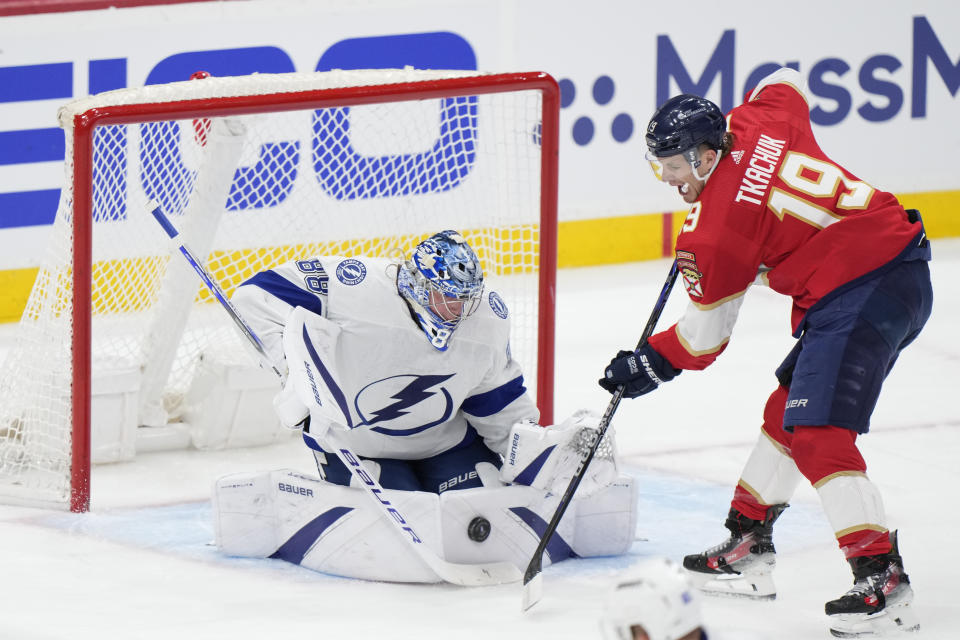 Florida Panthers left wing Matthew Tkachuk (19) attempts a shot at Tampa Bay Lightning goaltender Andrei Vasilevskiy (88) during the first period of Game 1 of the first-round of an NHL Stanley Cup Playoff series, Sunday, April 21, 2024, in Sunrise, Fla. (AP Photo/Wilfredo Lee)