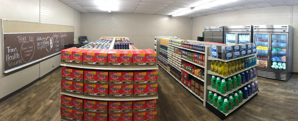 In this photo provided by Anthony Love, food and toiletries line the shelves of Linda Tutt High School's student-led free grocery store on Nov. 20, 2020, in Sanger, Texas. (Anthony Love via AP)