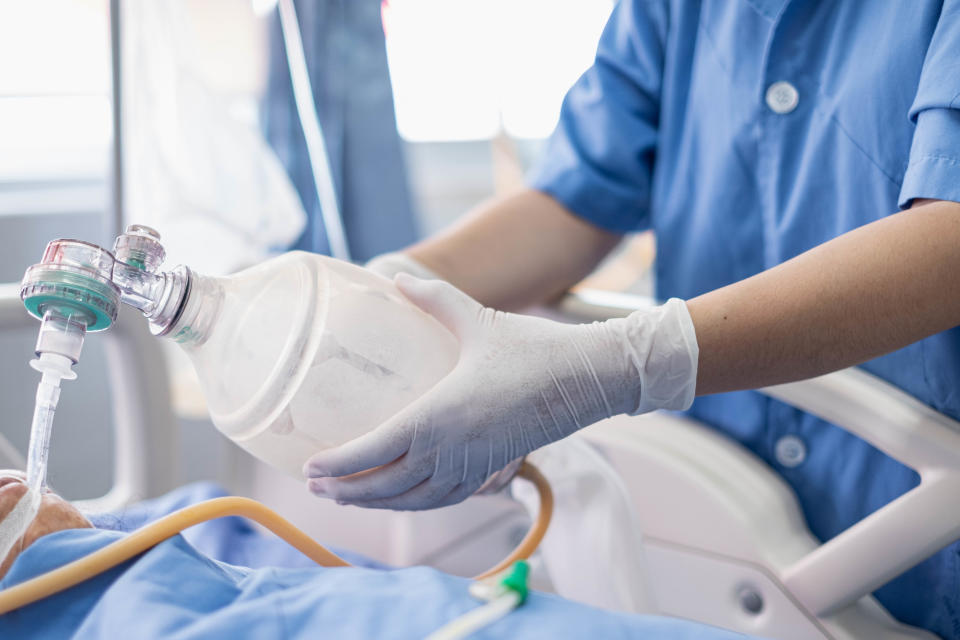 Doctor holding oxygen over patients in ICU/Emergency Room