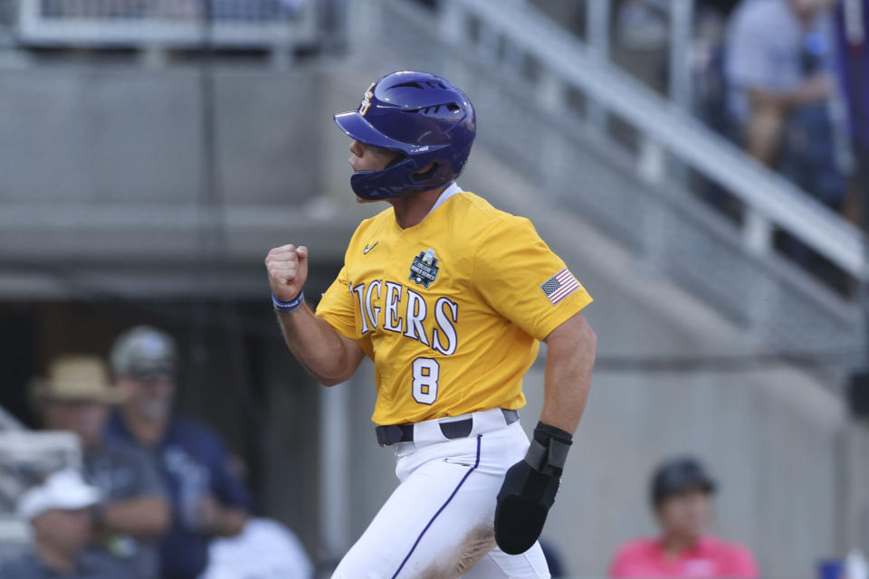 LSU's Gavin Dugas (8) crosses the plate after scoring on an RBI by Jordan Thompson in the second inning of Game 3 of the NCAA College World Series baseball finals against Florida in Omaha, Neb., Monday, June 26, 2023. (AP Photo/Rebecca S. Gratz)