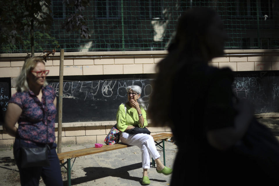 Marta Saracyn, left, and Helise Lieberman, center, take part in an interview with The Associated Press, outside the Lauder Morasha Jewish school in Warsaw, Poland, Thursday, July 28, 2022. A special summer camp run by Jewish organizations has brought Jewish volunteers from the former Soviet Union to Warsaw to help Ukrainian children. The camp, which ran for most of July and ended Friday, was organized to bring some joy to traumatized children, help prepare them for the school year ahead in Polish schools and give their mothers some time to themselves. (AP Photo/Michal Dyjuk)