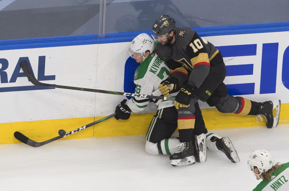 Dallas Stars' Joel Kiviranta (25) is checked by Vegas Golden Knights' Nicolas Roy (10) during the third period of Game 2 of the NHL hockey Western Conference final, Tuesday, Sept. 8, 2020, in Edmonton, Alberta. (Jason Franson/The Canadian Press via AP)