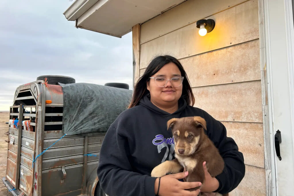 Katherine Goodlow holds Coco outside her grandmother's home in Hisle on the Pine Ridge Reservation in South Dakota.