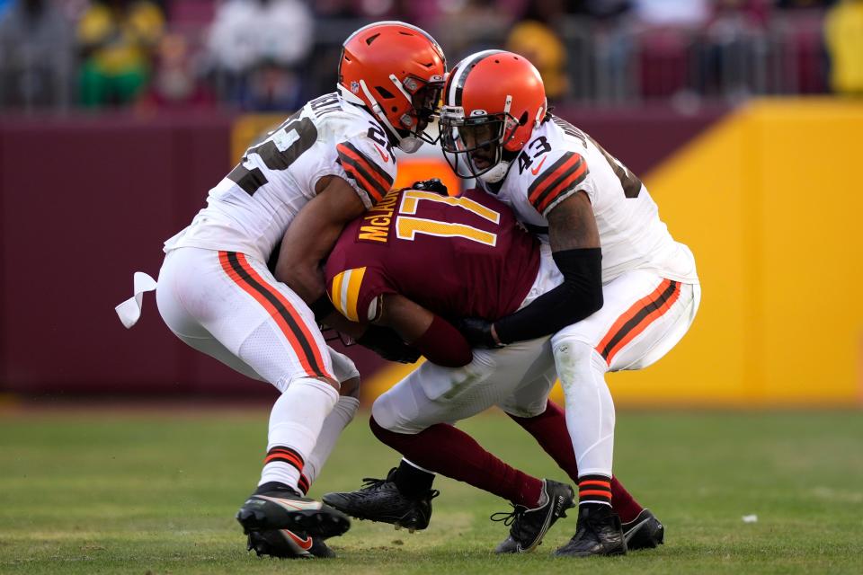 Washington Commanders wide receiver Terry McLaurin (17) is tackled by Cleveland Browns safety Grant Delpit (22) and safety John Johnson III (43) during the second half of an NFL football game, Sunday, Jan. 1, 2023, in Landover, Md. (AP Photo/Susan Walsh)