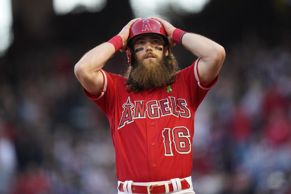 Los Angeles Angels' Brandon Marsh (16) adjusts his helmet after reaching third during the first inning of a baseball game against the Tampa Bay Rays in Anaheim, Calif., Tuesday, May 10, 2022. (AP Photo/Ashley Landis)