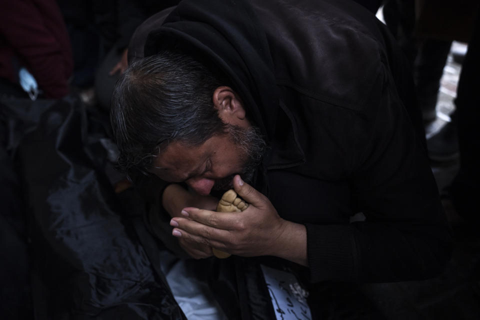 A Palestinian mourns a relative killed in the Israeli bombardment of the Gaza Strip, outside a morgue in Rafah, southern Gaza, Tuesday, Feb. 6, 2024. (AP Photo/Fatima Shbair)