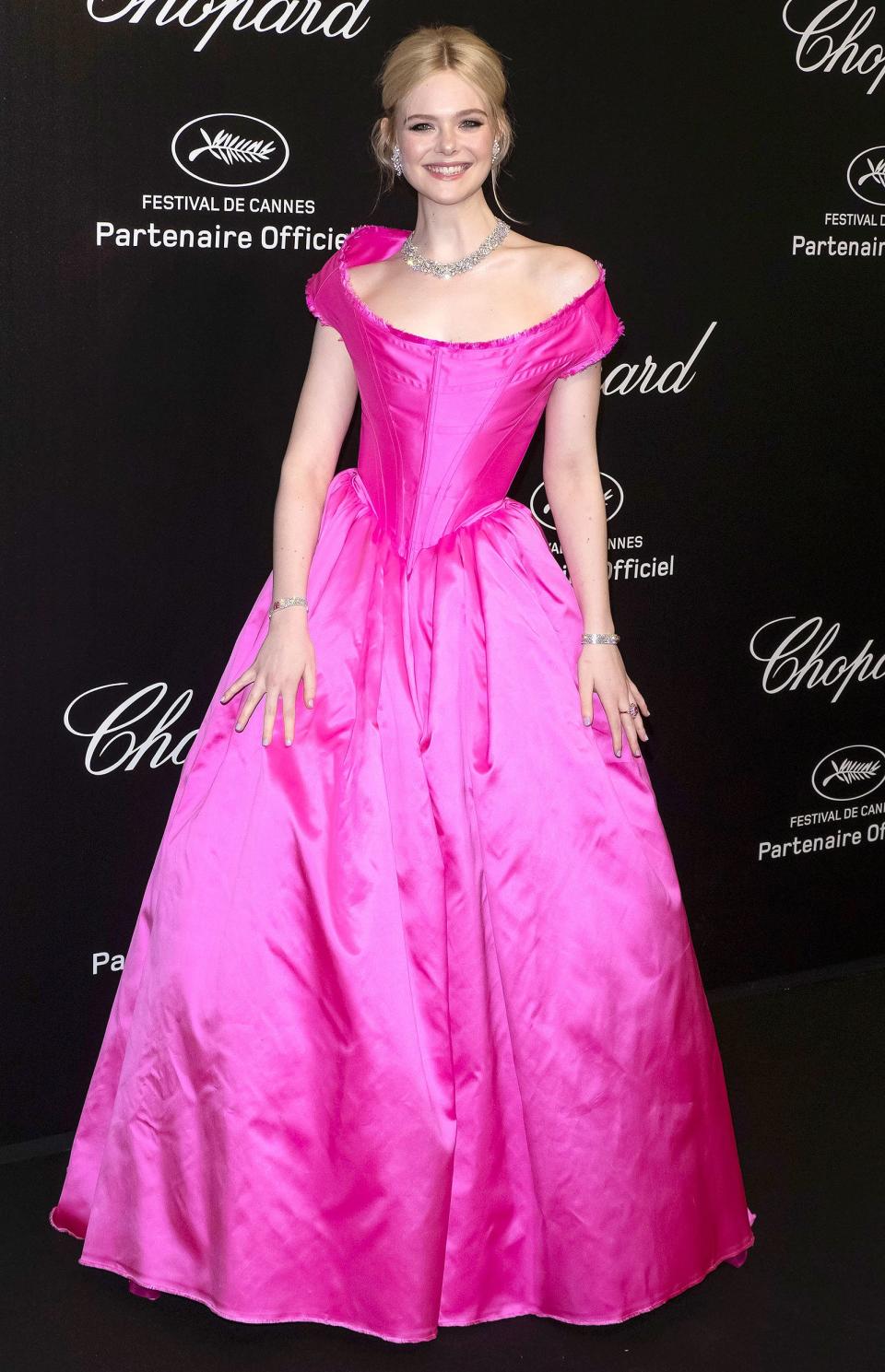 The actress lives a fashion fantasy at the Chopard party wearing a corseted, neon pink Vivienne Westwood Couture gown worn with a Chopard jewels from the "Red Carpet Collection" including a necklace and earrings featuring 67.79-carats of rose-cut diamonds, 61.06-carats of round-shaped diamonds, 55.20-carats of heart-shaped diamonds, and 1.06-carats of diamonds in 18k white gold.