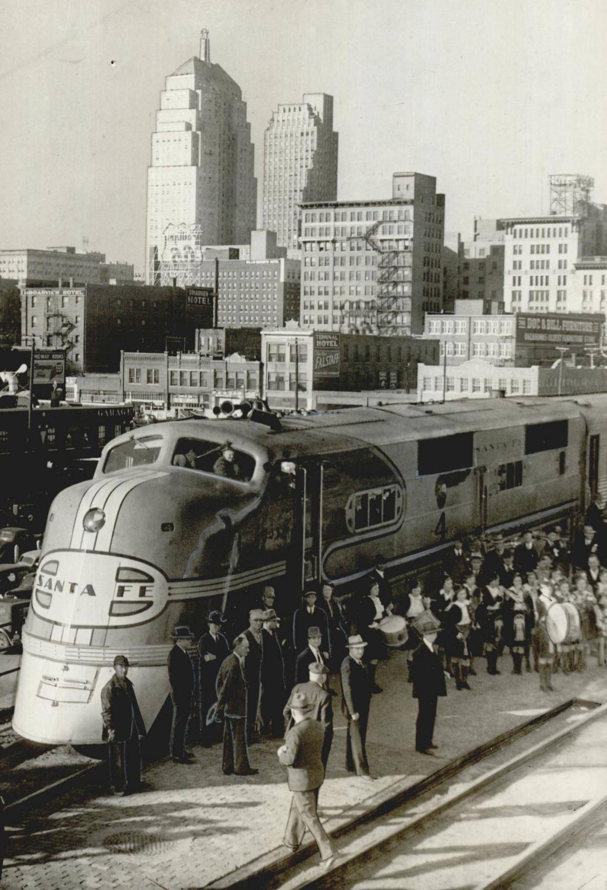 A Santa Fe streamliner rests on the tracks with the Oklahoma City skyline in the background in 1939.