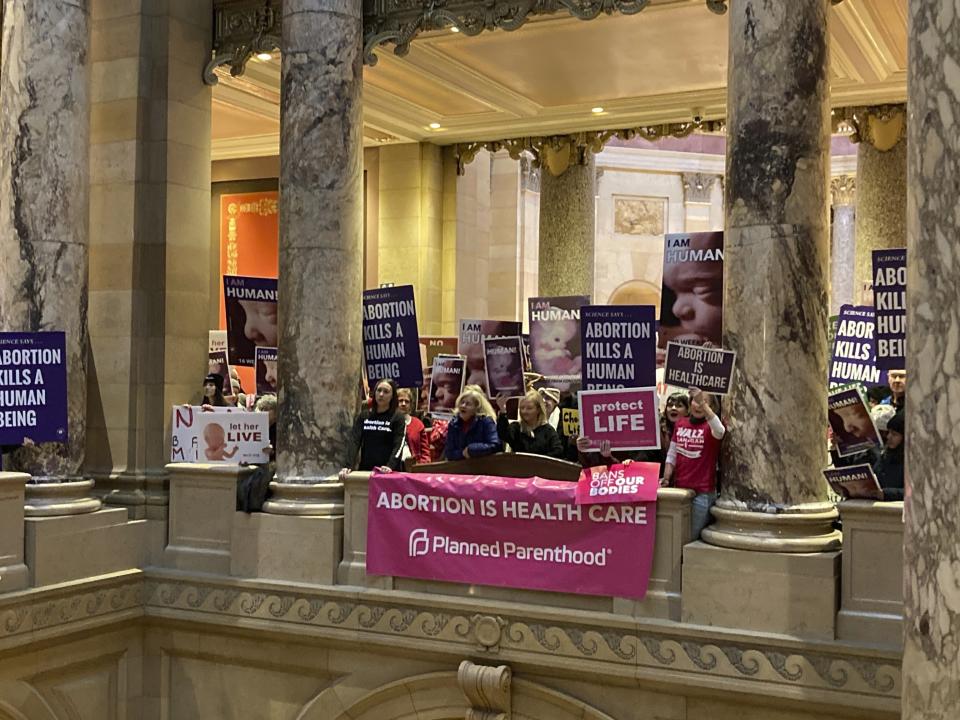 Abortion protesters on both sides pack the halls outside the Minnesota Senate chamber on Friday, Jan. 27, 2023, at the State Capitol in St. Paul, Minn. The Minnesota Senate is debating a bill Friday to write broad protections for abortion rights into state statutes, which would make it difficult for future courts to roll back. (AP Photo/Steve Karnowski)