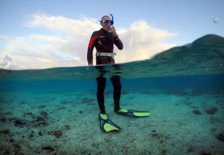 Peter Gash, owner and manager of the Lady Elliot Island Eco Resort, prepares to snorkel during an inspection of the reef's condition in an area called the 'Coral Gardens' located at Lady Elliot Island, north-east of the town of Bundaberg in Queensland, Australia, June 11, 2015. REUTERS/David Gray