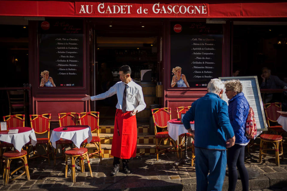 <div class="inline-image__caption"><p>A waiter shows empty tables to customers at a restaurant’s terrace on the Place du Tertre in Montmartre on March 30, 2017, in Paris.</p></div> <div class="inline-image__credit">Lionel Bonaventure/AFP via Getty</div>