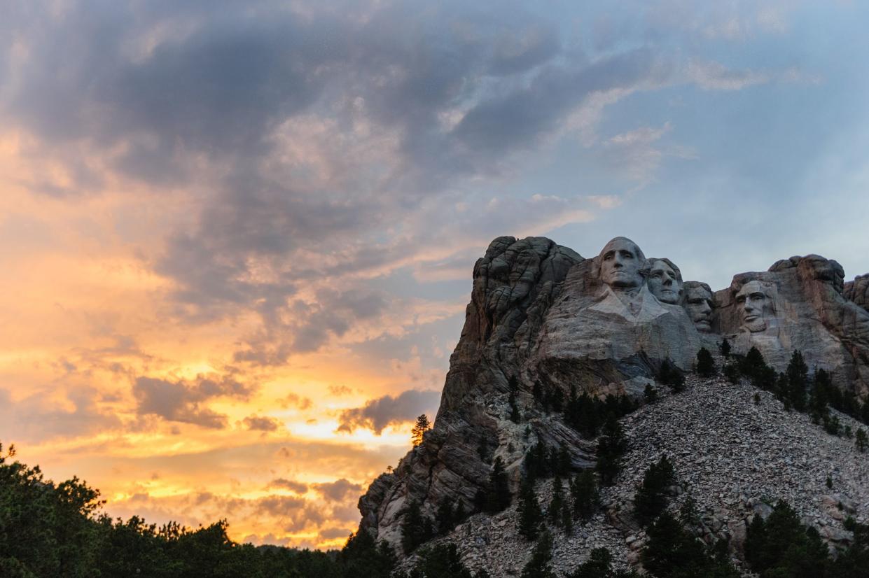 Bright Sunset colors behind Mount Rushmore National Monument