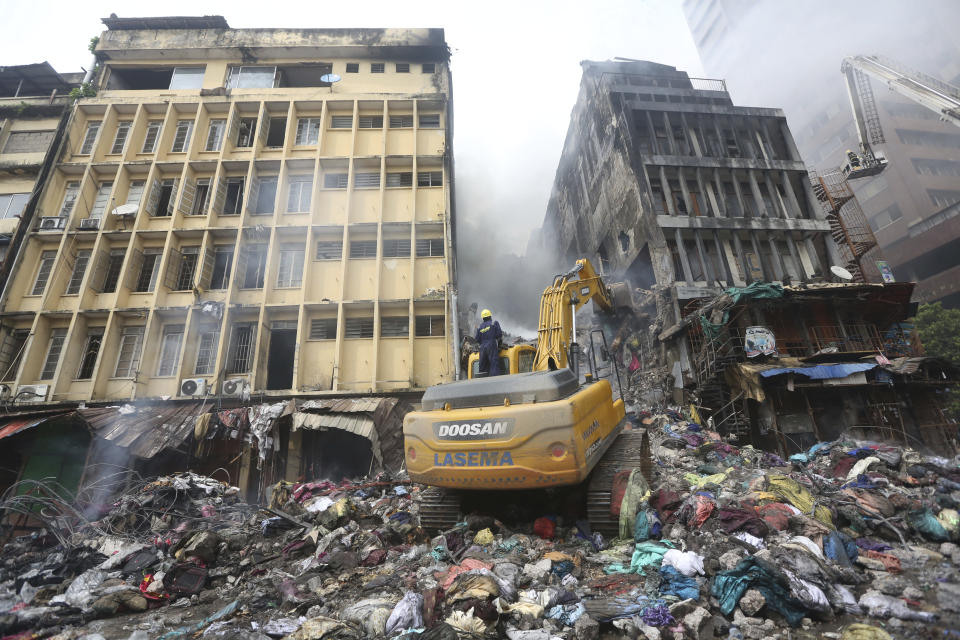 A crane operator works at the site of a fire in Balogun Market in downtown Lagos, Nigeria, Nov. 6, 2019. (Photo: Sunday Alamba/AP)