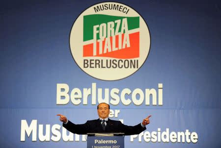 FILE PHOTO: Forza Italia party leader Silvio Berlusconi waves during a rally for the regional elections in Palermo, Italy November 1, 2017. REUTERS/Guglielmo Mangiapane/File Photo/File Photo