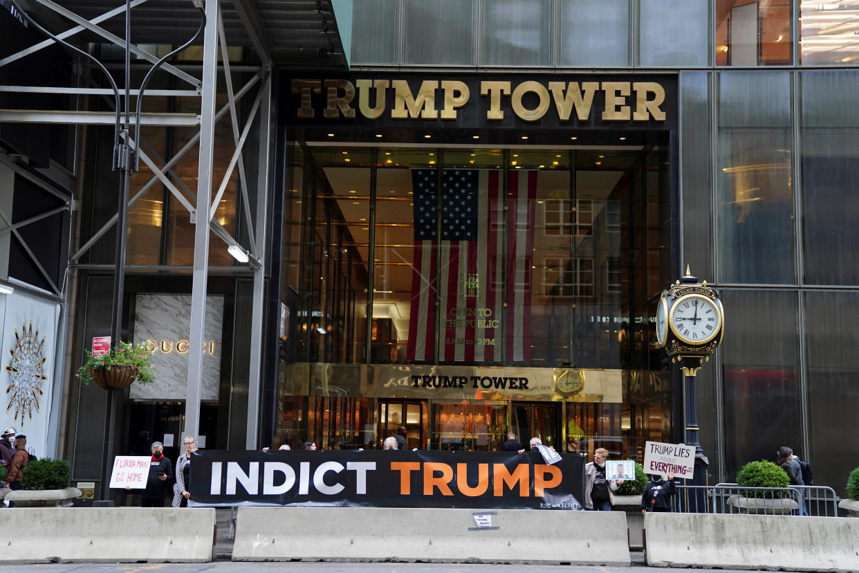 Protesters hold up signs outside Trump Tower in Manhattan, New York City. (Carlo Allegri/Reuters)