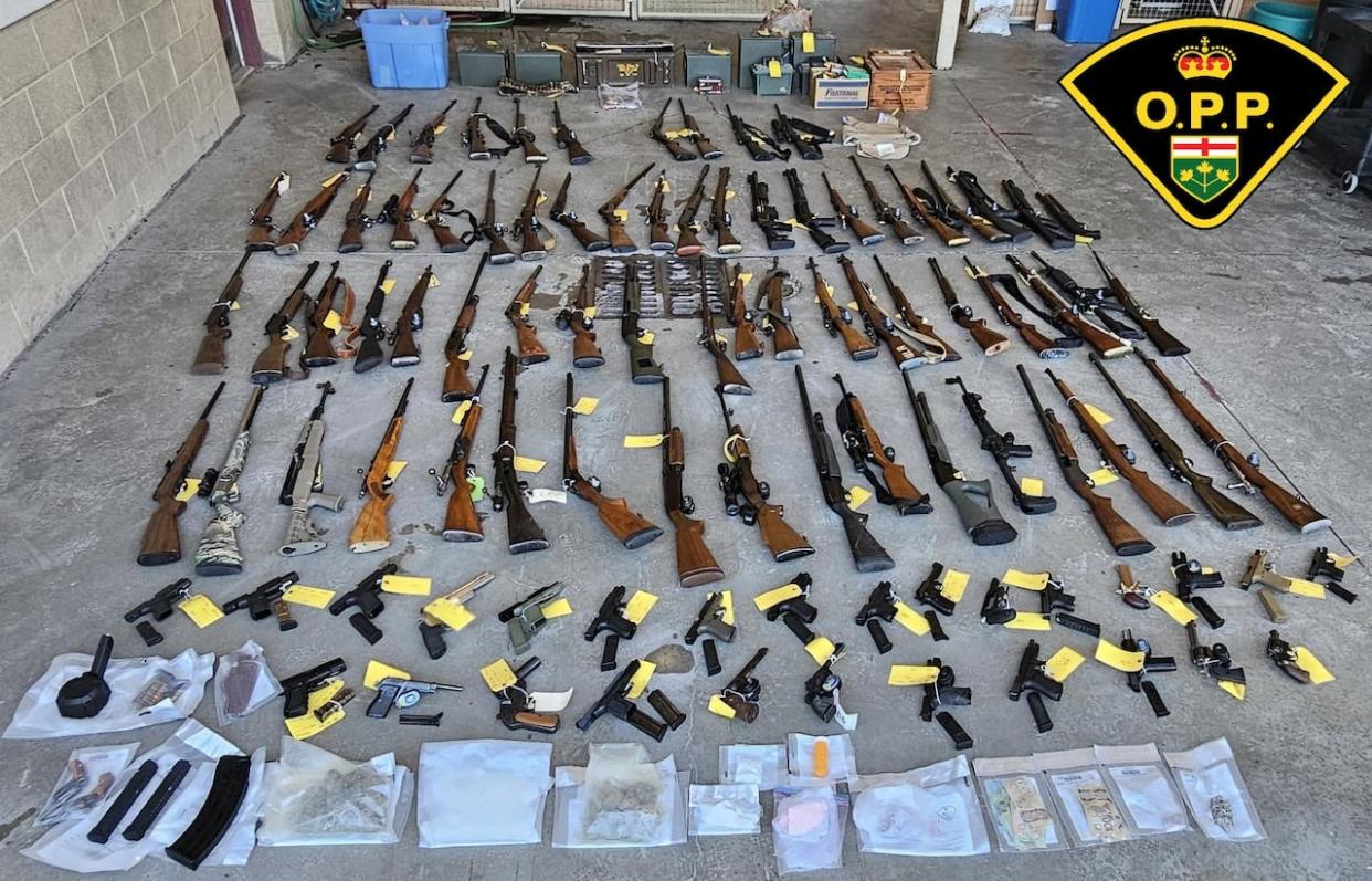 Provincial police say officers seized nearly 100 firearms following a May 24, 2024, raid at a home in Tyendinaga Township. (OPP - image credit)