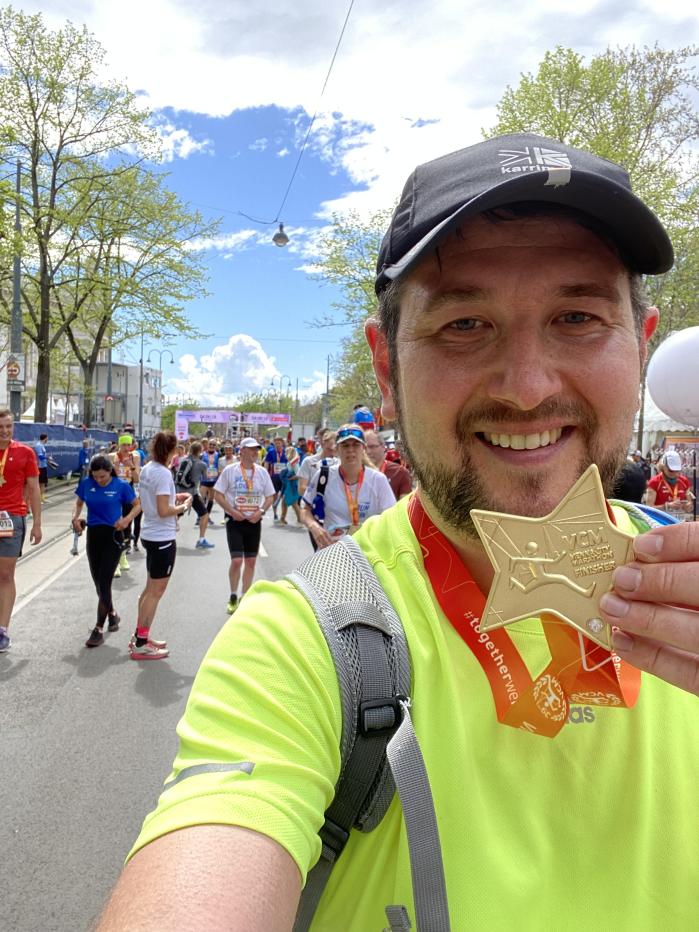 Man holding star shaped medal to the camera 