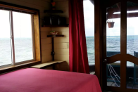 <p>Here’s another bedroom with a beautiful view of the waters. <br> (Airbnb) </p>