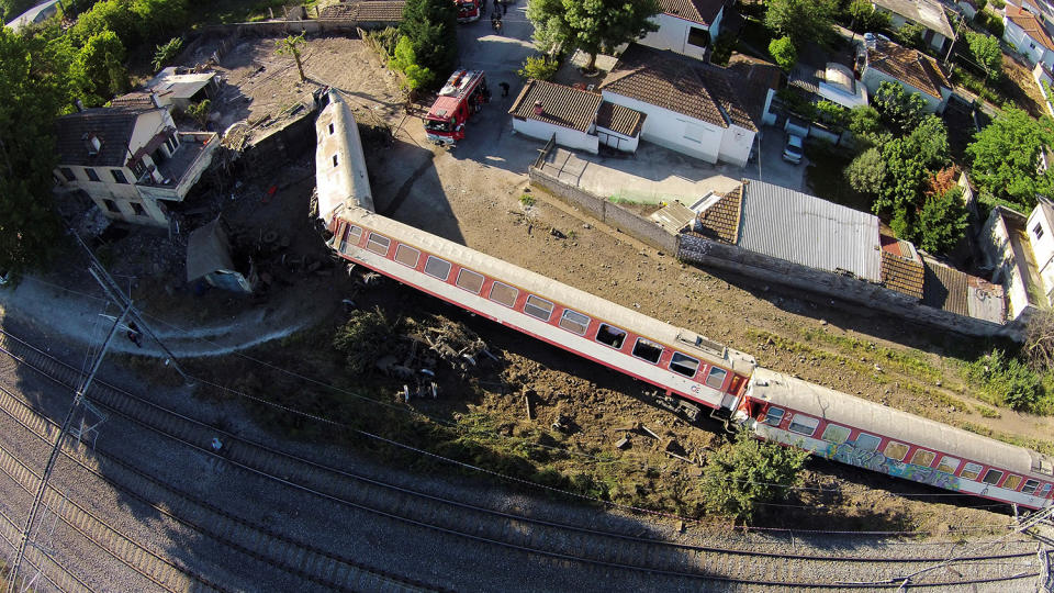 <p>A train is shown toppled on its side after derailing and crashing into a house in the town of Adendro in northern Greece, May 14, 2017. (Photo: Petros Kefalas/www.emvolos.gr via Reuters) </p>