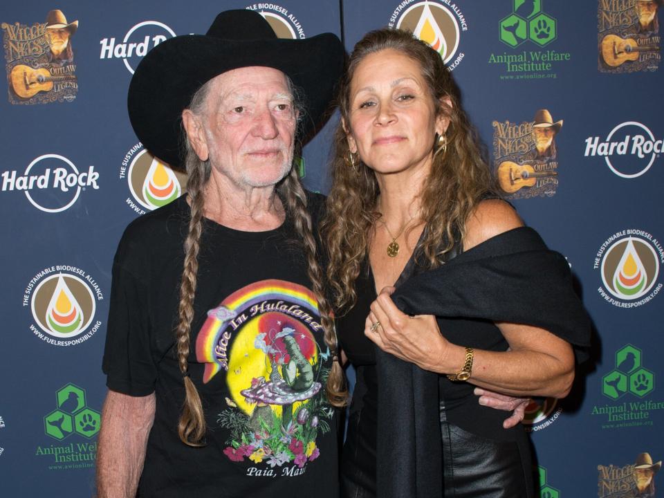 Willie Nelson and Annie D'Angelo attend Hard Rock International's Wille Nelson Artist Spotlight Benefit Concert at Hard Rock Cafe, Times Square on June 6, 2013 in New York City