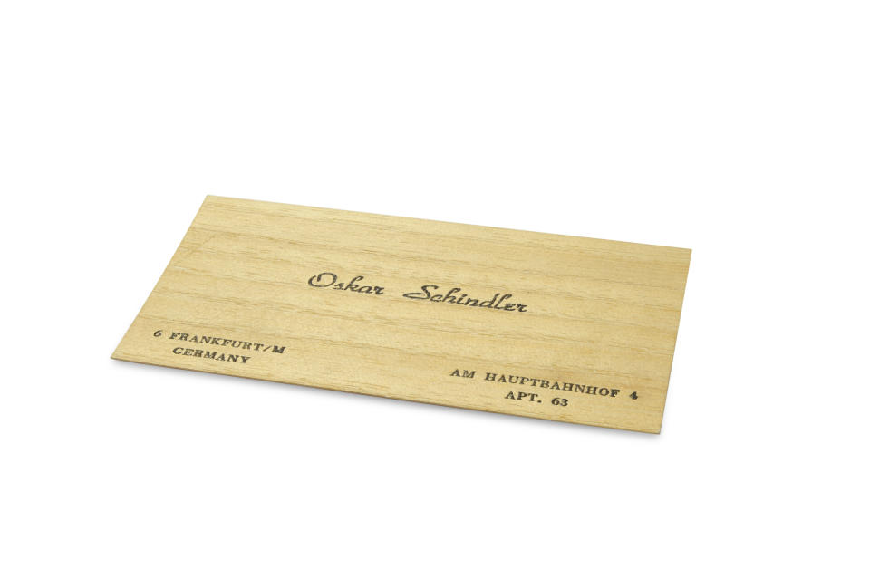 This Feb. 25, 2019 photo shows a wooden business card. Several personal possessions of Oskar Schindler, the German industrialist credited with saving the lives of more than 1,000 Jews during World War II, are up for auction. Schindler's Longines wristwatch, a compass he and his wife reportedly used in 1945 as they fled advancing Russian troops, two Parker fountain pens in a case, and several other items are being sold by RR Auction of Boston. The belongings are being sold as a package and are expected to fetch about $25,000 in the auction that ends March 6. (Howard Fohlin/RR Auction via AP)