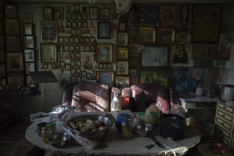 A cat sits on a chair in a kitchen at Pishchanskyi church in the recently liberated town of Izium, Ukraine, Monday, Sept. 21, 2022. At one point, the church and monastery compound had become a shelter for around 100 people, including 40 children. (AP Photo/Evgeniy Maloletka)