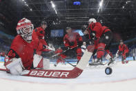 A shot by United States' Ben Meyers gets past Canada goalkeeper Eddie Pasquale (80) for a goal during a preliminary round men's hockey game at the 2022 Winter Olympics, Saturday, Feb. 12, 2022, in Beijing. (Bruce Bennett/Pool Photo via AP)