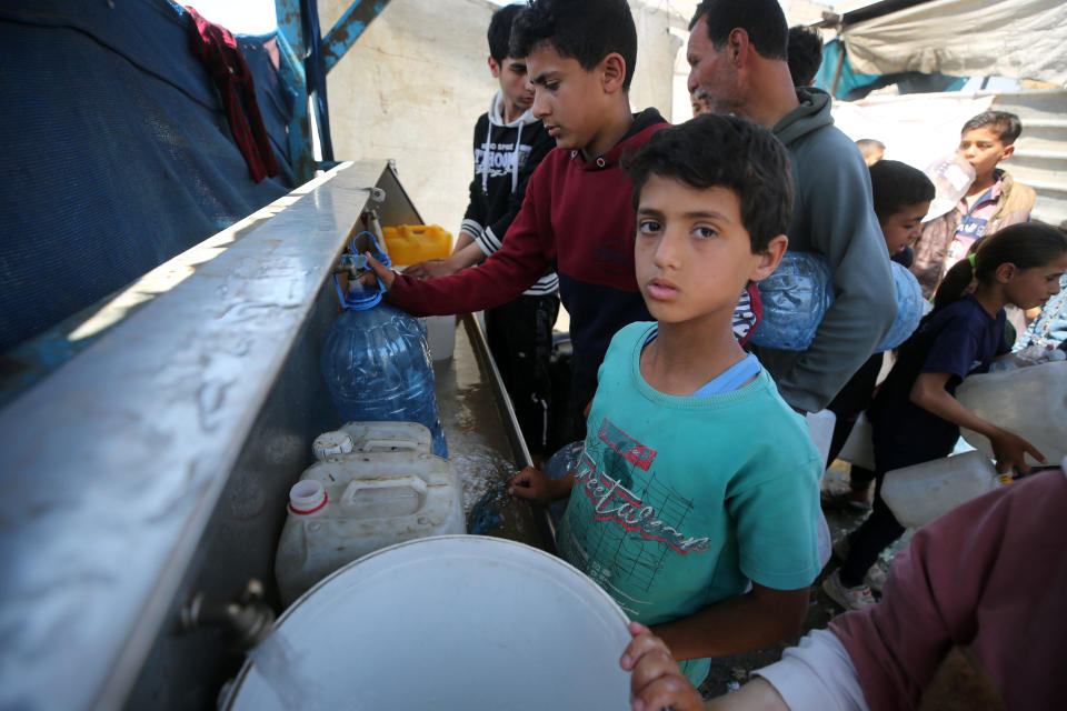 Palestinians wait in front of water dispensers in Rafah, Gaza, to meet their daily water needs April 17, 2024. / Credit: Yasser Qudaih/Anadolu via Getty Images