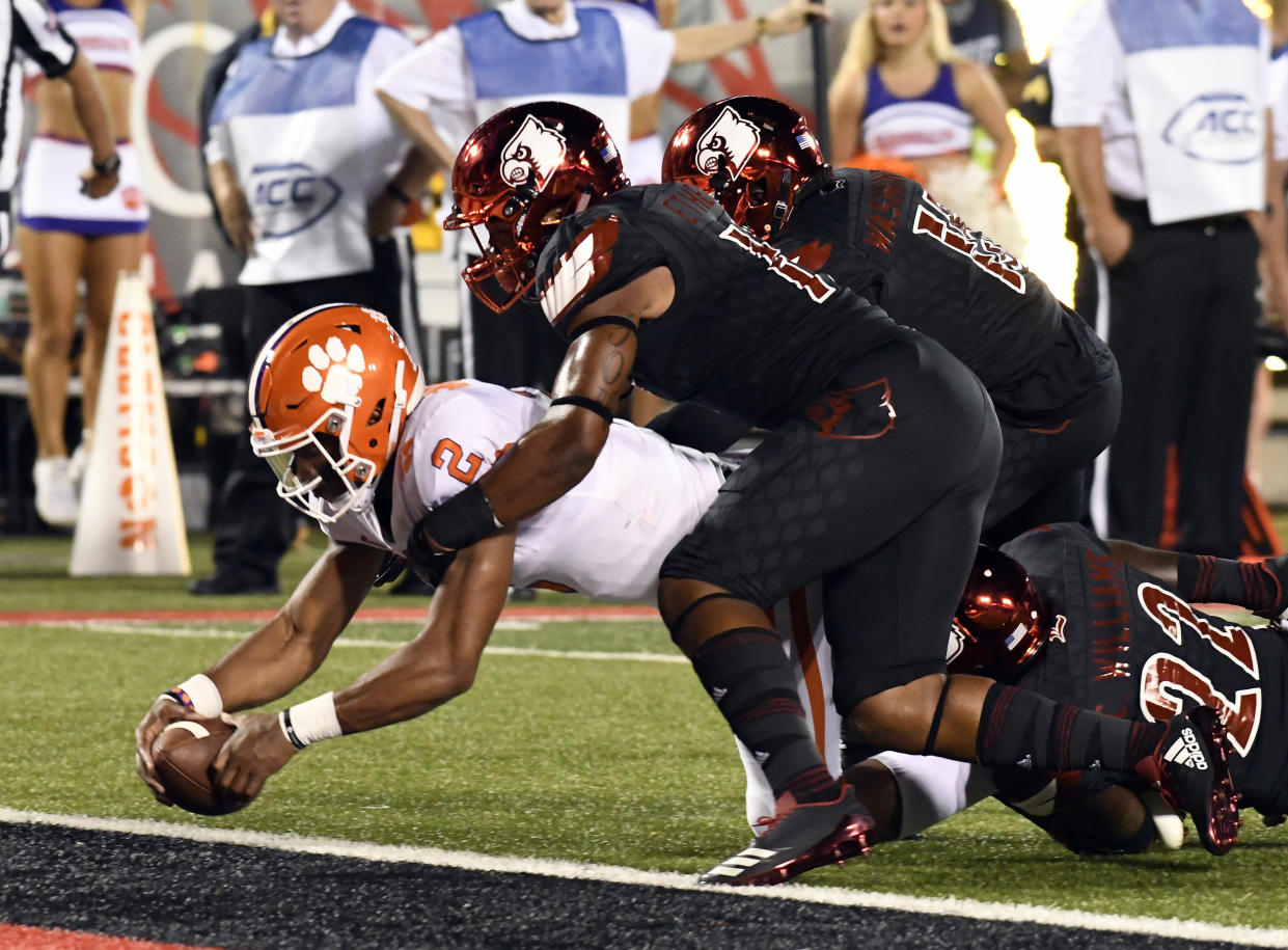 Clemson quarterback Kelly Bryant (2) is brought down by Louisville’s Dorian Etheridge, front right, and Trumaine Washington (15) as he crosses the goal line during the first half of an NCAA college football game, Saturday, Sept. 16, 2017, in Louisville, Ky. (AP Photo/Timothy D. Easley)