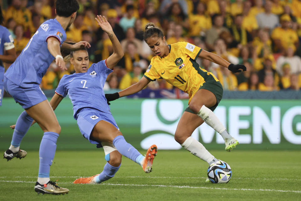 Australia's Mary Fowler, right, challenges for the ball with France's Maelle Lakrar during the Women's World Cup quarterfinal soccer match between Australia and France in Brisbane, Australia, Saturday, Aug. 12, 2023. (AP Photo/Tertius Pickard)