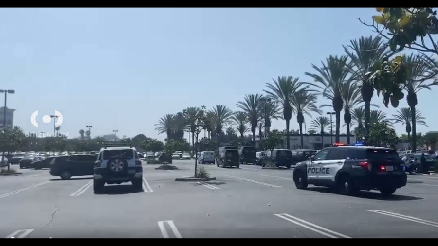 Police cordon off a parking lot after shots were reportedly fired at the Downey Landing shopping center in Downey on June 11, 2024. (Citizen)