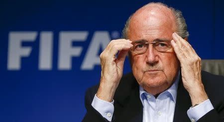 FIFA President Sepp Blatter adjusts his glasses as he addresses a news conference after a meeting of the FIFA executive committee in Zurich September 26, 2014. Reuters/Arnd Wiegmann