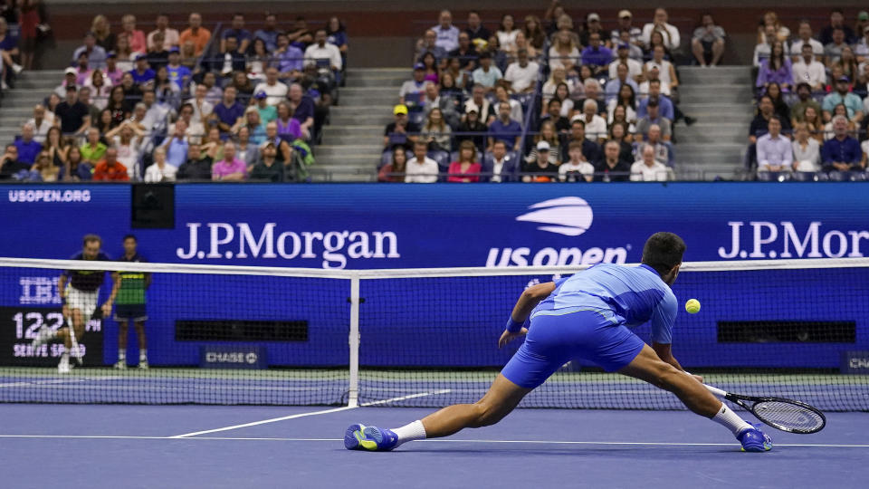 Novak Djokovic, of Serbia, attempts to return a shot at the net to Daniil Medvedev, of Russia, during the men's singles final of the U.S. Open tennis championships, Sunday, Sept. 10, 2023, in New York. (AP Photo/Charles Krupa)