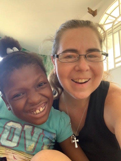 Autumn Marshall (right) with one of the children she has been helping in Haiti.