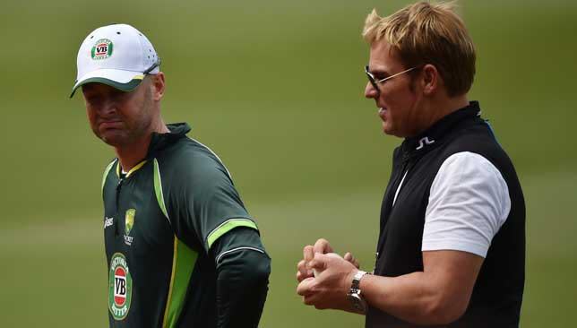 Shane Warne discussing tactics with Michael Clarke