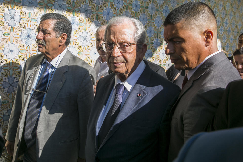 Tunisian parliament president Mohamed Ennaceur, center, arrives to be sworn in as Interim president in Tunis, Tunisia, Thursday, July 25, 2019. Ennaceur, the leader of Tunisia's parliament has been sworn in as the interim president of the North African country after 92-year-old President Beji Essebsi died in office. The state news agency TAP reported that Mohamed Ennaceur, president of the Assembly of People's Representatives, took the oath of office Thursday July 25, hours after Essebsi's death in the morning. (AP Photo/Hassene Dridi)