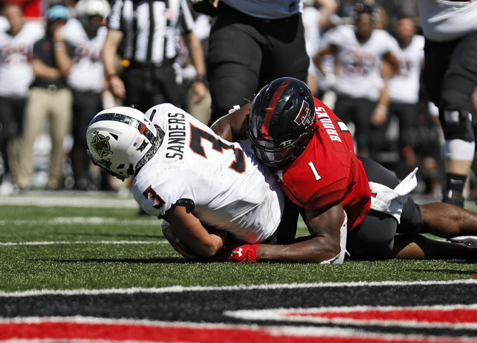 Texas Tech's Jordyn Brooks (1) tackles Oklahoma State's Spencer Sanders (3) to stop a two-point conversion during the second half of an NCAA college football game Saturday, Oct. 5, 2019, in Lubbock, Texas. (AP Photo/Brad Tollefson)