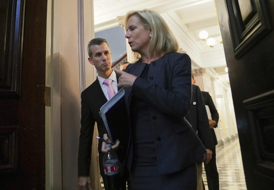 FILE - In this Aug. 16, 2018, file photo, Homeland Security Secretary Kirstjen Nielsen, foreground, talks with Max Schachter, left, father of Alex Schachter, who was killed during the Marjory Stoneman Douglas High School shooting, as they arrive for a meeting of the Federal Commission on School Safety in the Indian Treaty Room of the Eisenhower Executive Office Building in Washington. "After 9/11, we hardened the cockpits and the airports," Schachter testified during that day's commission hearing. "The reasons these monsters are still attacking our schools is because they're extremely soft targets. (AP Photo/Pablo Martinez Monsivais, File)