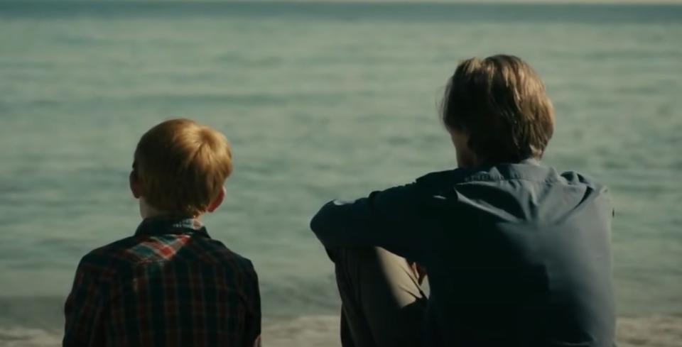 Dad and son looking out at water