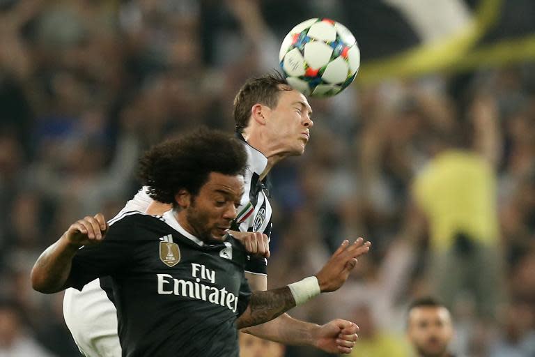 Juventus' defender from Switzerland Stephan Lichtsteiner (R) fights for the ball with Real Madrid's Brazilian defender Marcelo during the UEFA Champions League semi-final first leg football match on May 5, 2015 at the Juventus stadium in Turin