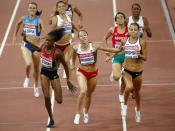 Marina Arzamasova of Belarus (C) crosses the finish line ahead of second-placed Melissa Bishop of Canada (R) and third-placed Eunice Jepkoech Sum of Kenya (L) to win the women's 800 metres final at the 15th IAAF Championships at the National Stadium in Beijing, China August 29, 2015. REUTERS/David Gray