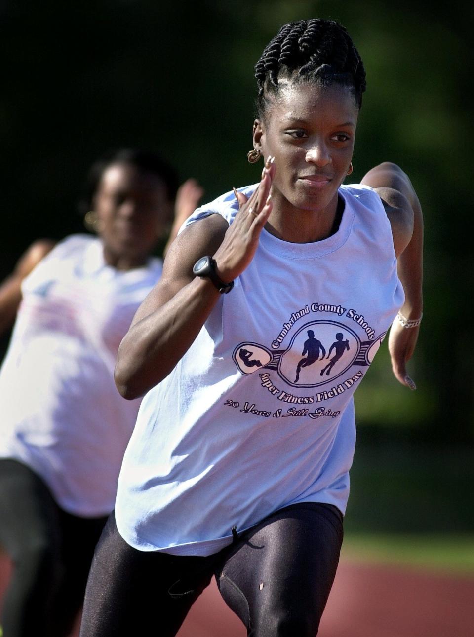 Jack Britt's Courtney Patterson practices for the 4x100 relay Tuesday with her teammates in 2002.