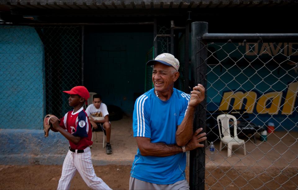 The uncle of Detroit Tigers' Miguel Cabrera, Jose Torres, watches a practice at the baseball field where Cabrera learned to play, in Maracay, Venezuela, Friday, March 28, 2014. Unlike many Latin American countries, where soccer is king, baseball is the national obsession in Venezuela, cutting across classes and political ideologies. Cabrera was born into a family particularly wrapped up in the sport. His uncle Jose played professionally with the local Tigres de Aragua team, and his mother Gregoria was a member of the national softball team for 12 years. (AP Photo/Alejandro Cegarra)
