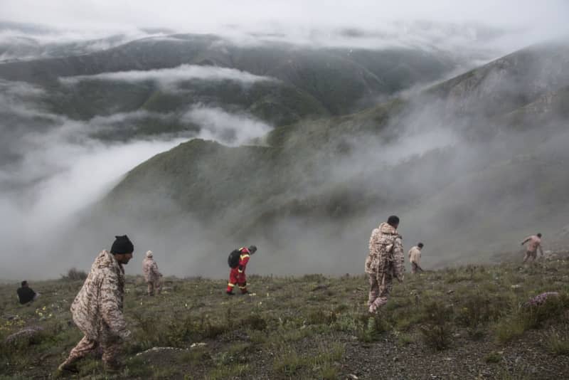 Iranian rescue team members work at the crash site of the helicopter that was carrying Iranian Presidnet Raisi in Varzaghan, north-west Iran. Azin Haghighi/Moj News/ZUMA Press Wire/dpa