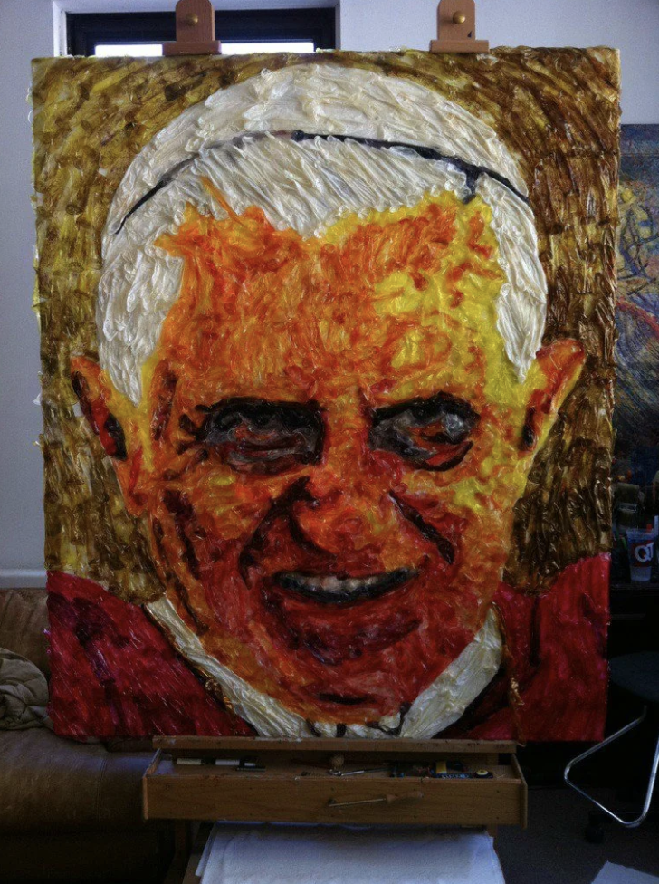 The pope's smiling face made out of melted condoms that look like paint